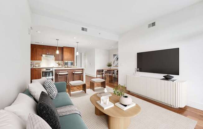 A living room with a couch, a coffee table, and a television.