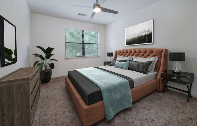 The Hendrix Apartments bedroom with bed and ceiling fan at The Hendrix, Atlanta
