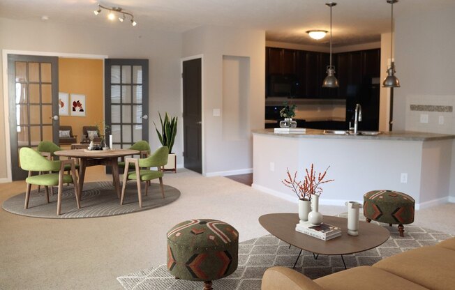 a living room and kitchen with a table and chairs