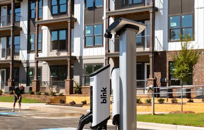 an electric car charger in front of an apartment building