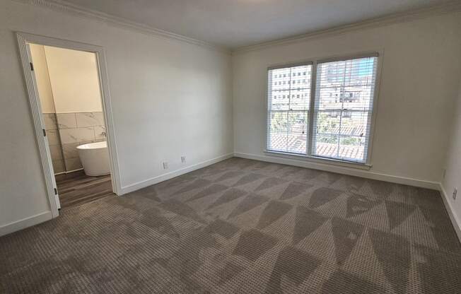 an empty living room with a large window