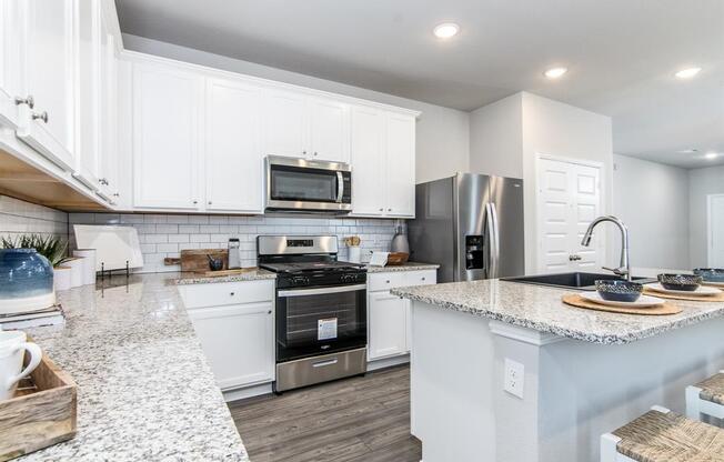 a kitchen with a stove top oven next to a sink