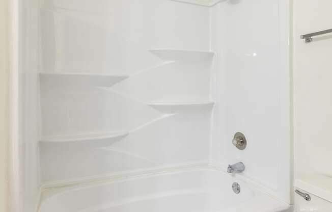 A white bathroom cabinet with shelves and a towel bar at Spring Creek Townhomes Apartments, Illinois