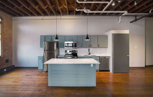 A kitchen with a blue island in the middle of the room.