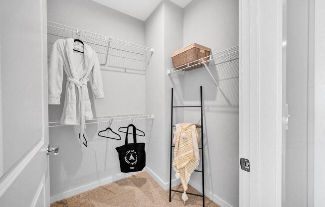 a closet with a rack and clothes hanging on the wall