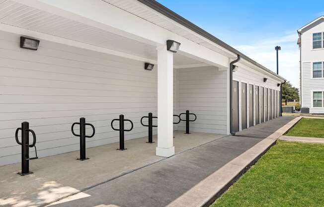 a row of garage doors at the whispering winds apartments in pearland, tx