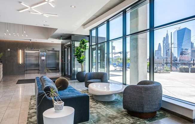 A modern lobby with a view of the city skyline.