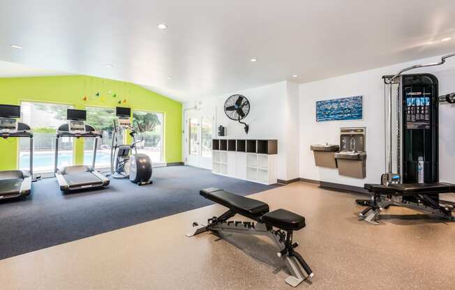 a gym with exercise equipment and a large window