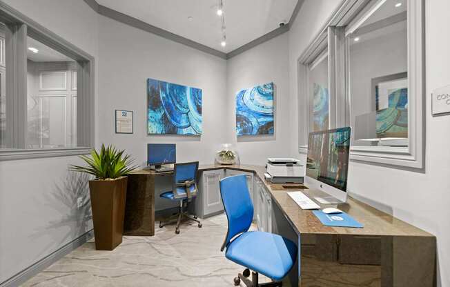 A modern office with a blue chair and a brown desk.