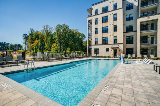 a swimming pool with a building in the background