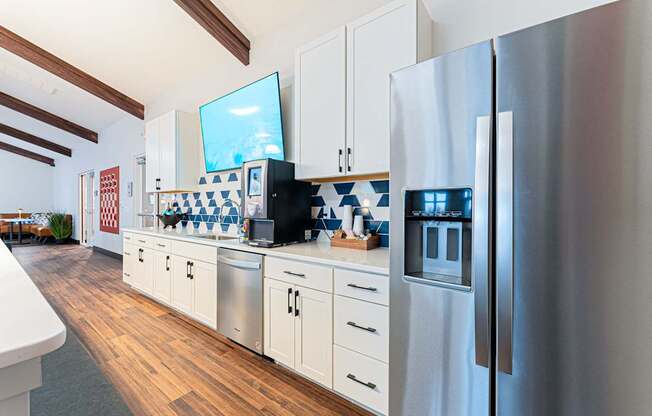 A modern kitchen with a refrigerator on the right.