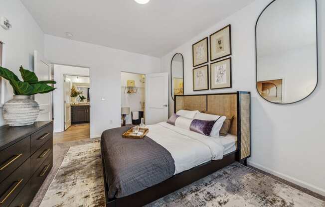 a bedroom with a large bed and a mirror  at Plat 4 at Research Triangle, Durham