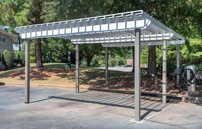 A carport with a metal roof and pillars.