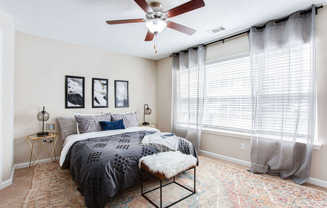 a bedroom with a bed and a ceiling fan