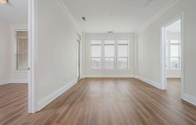 a bedroom with hardwood floors and white walls