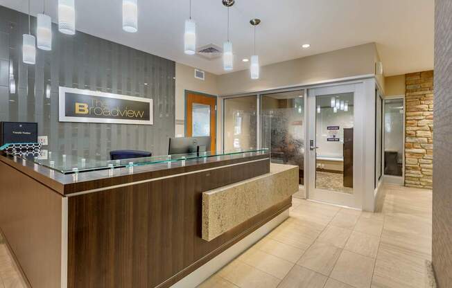 A reception area with a wooden counter and a glass wall.