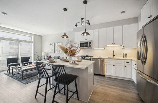 a kitchen and living room with a table and chairs