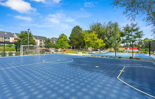A basketball court with a blue surface and white lines.