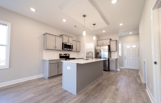 Elegant Home with Stone Fireplace, Kitchen Island and Designer Primary Suite