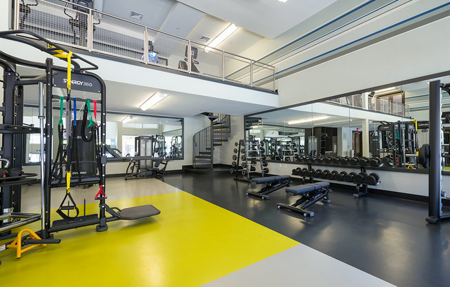Well equipped fitness center featuring machines and free weights