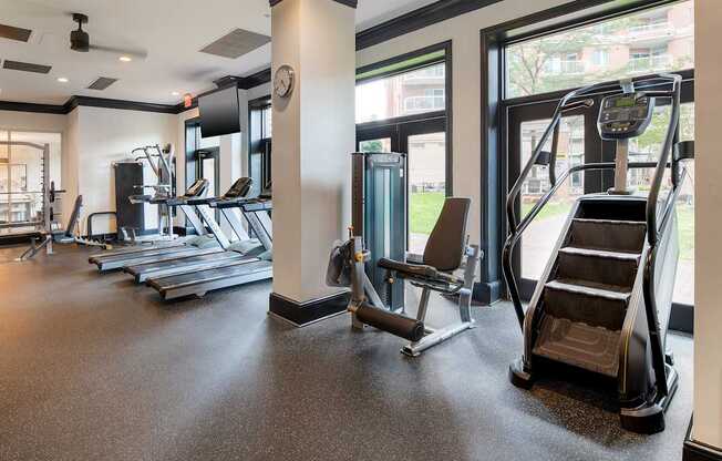 A gym with treadmills, elliptical machines, and other exercise equipment.
