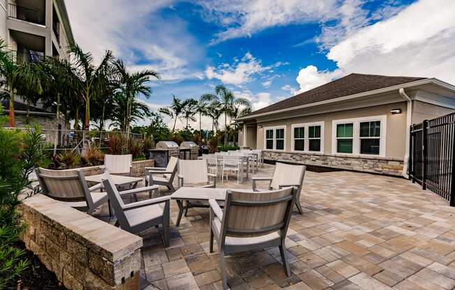 several chairs and tables in front of Vantage apartments clubhouse building