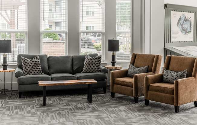 a living room with couches and chairs and a table