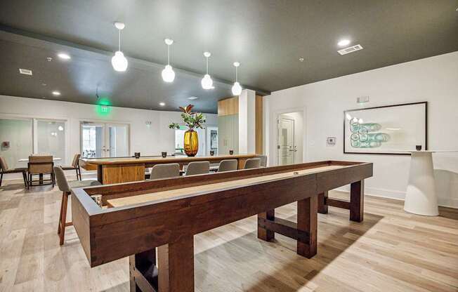 A room with a long table and chairs.