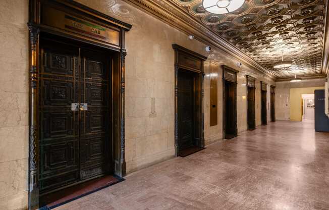 a hallway of elevators and doors in a building