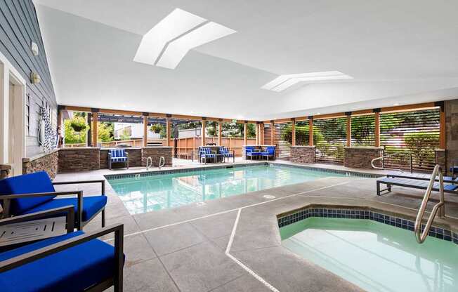 A large indoor swimming pool with a slide.