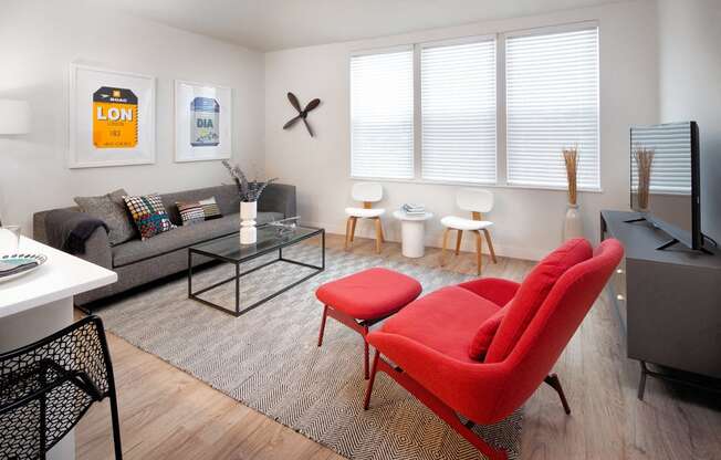 The mastlight model apartment common space with large couch windows and seating