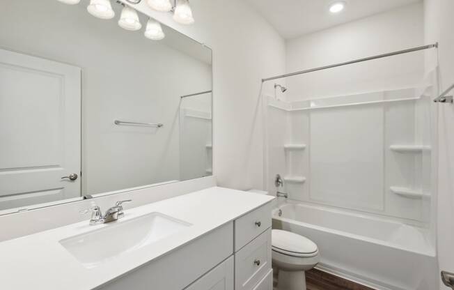 a bathroom with a sink toilet and bathtub
