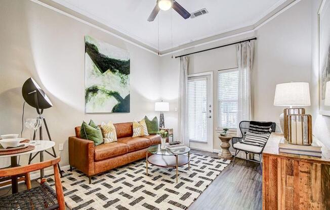 a living room with a couch and a ceiling fan