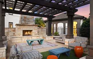 Twilight fireside lounge with stone fireplace and comfy seating