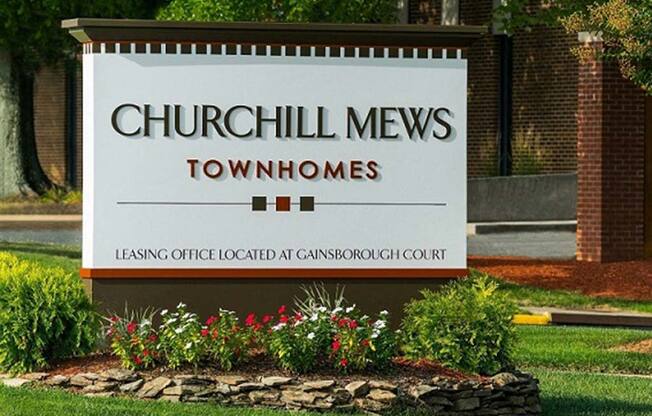 Placard with the Churchill Mews logo near apartments entrance