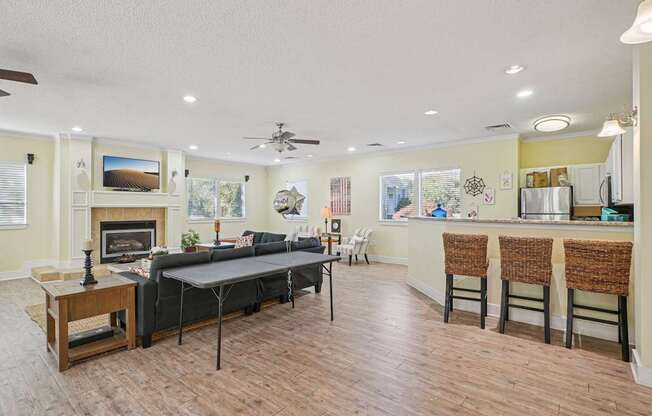 A living room with a fireplace and a dining table.