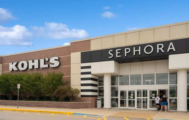 the facade of a sephora store with two people walking out of the door