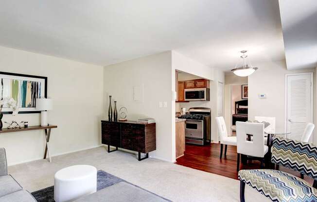 A modern living room with a white sofa and a grey ottoman.