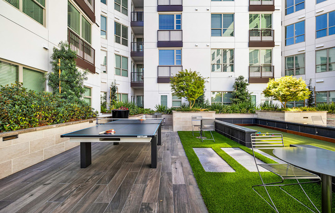Outdoor courtyard with ping pong and bocce, offering playful spaces to connect with friends and neighbors