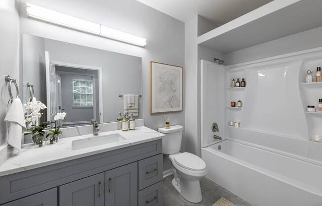 a white bathroom with a toilet sink and tub