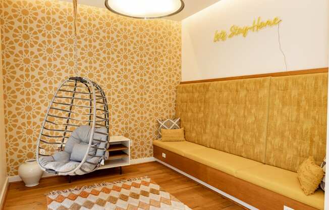 a room with a yellow couch and a white chair