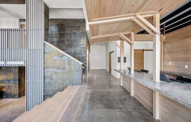 A modern interior with a wooden ceiling and a concrete wall.