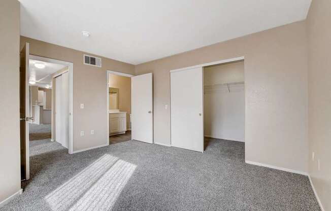 A room with a carpeted floor and white walls.