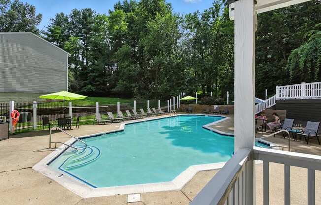 A pool with a white fence around it.