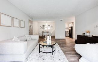 A living room with a white couch and a coffee table.