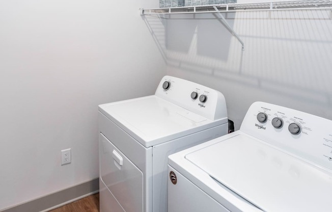 full size washer/dryer in a laundry room at Anthem Luxury Rentals and Apartments in Huntsville, AL