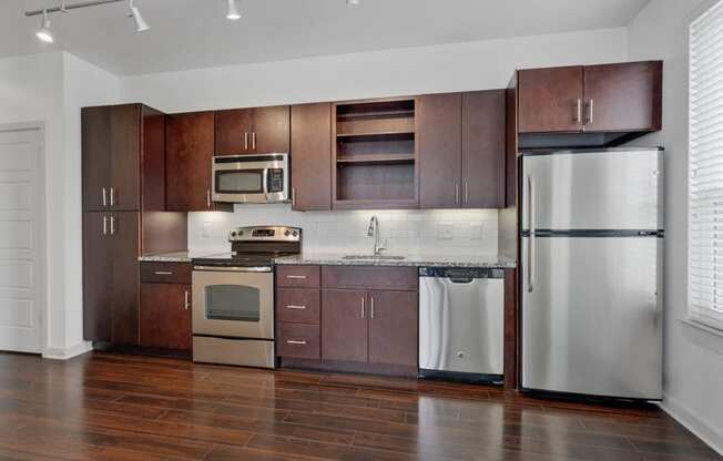 12 South Apartments - Nashville TN - kitchen with dark wood cabinets and stainless steel appliances