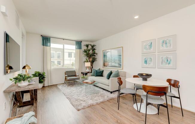 a living room filled with furniture and a large window