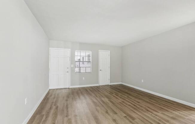 A room with wooden floors and white walls.