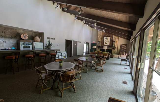 a dining room with tables and chairs and a bar